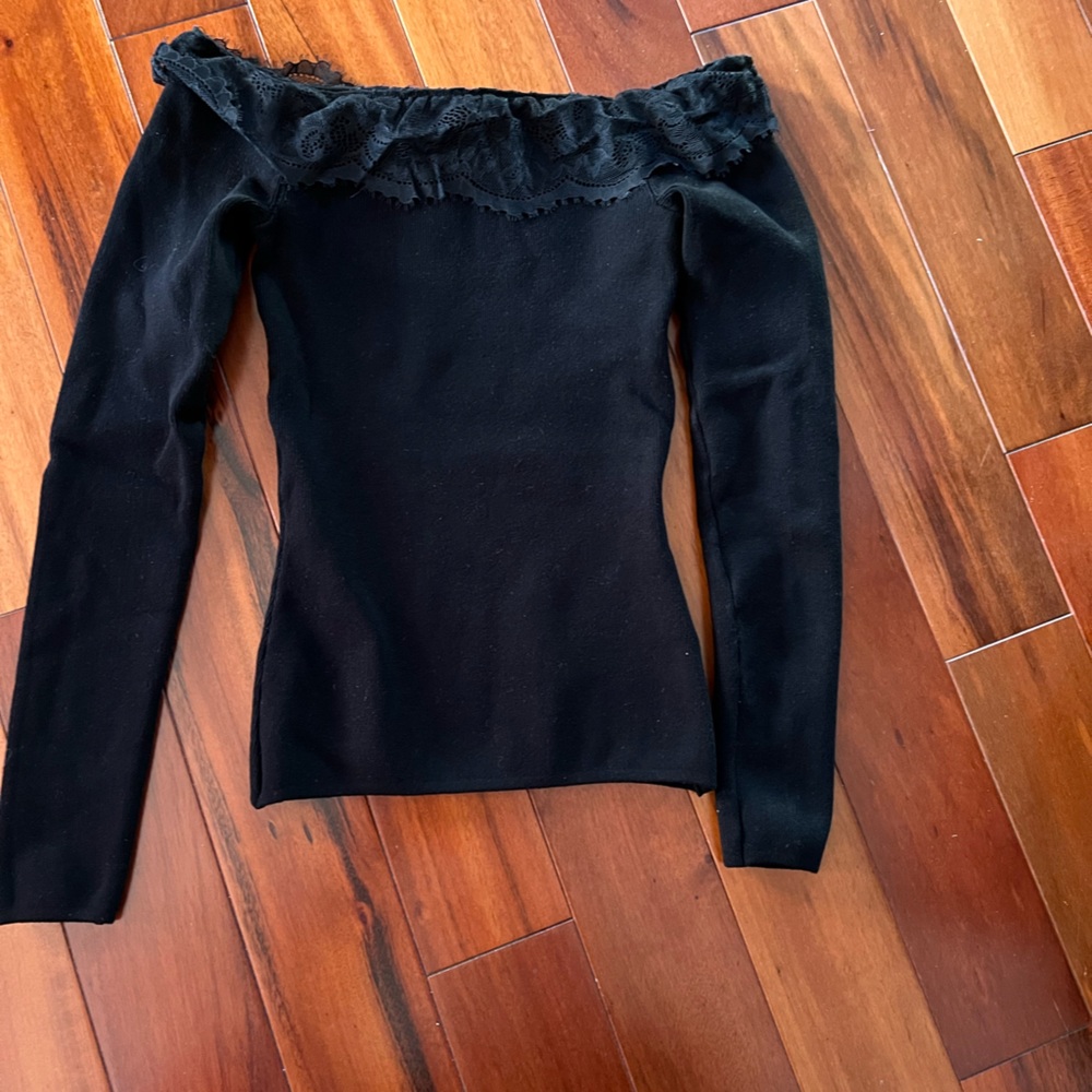 Super cute off the shoulder lace ruffle black top.